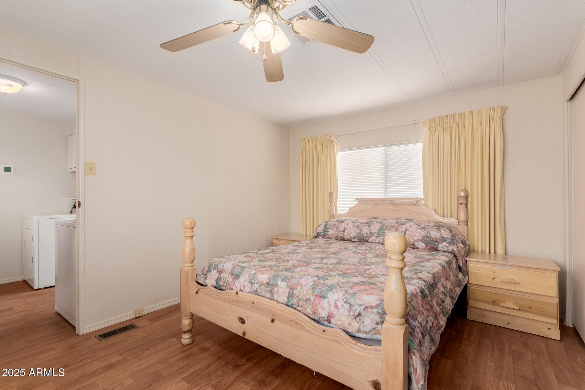 1050 East Broadway Avenue, Unit 84 Apache Junction, AZ 85119 - Photo 16 of 34 a bedroom with a bed and a chandelier