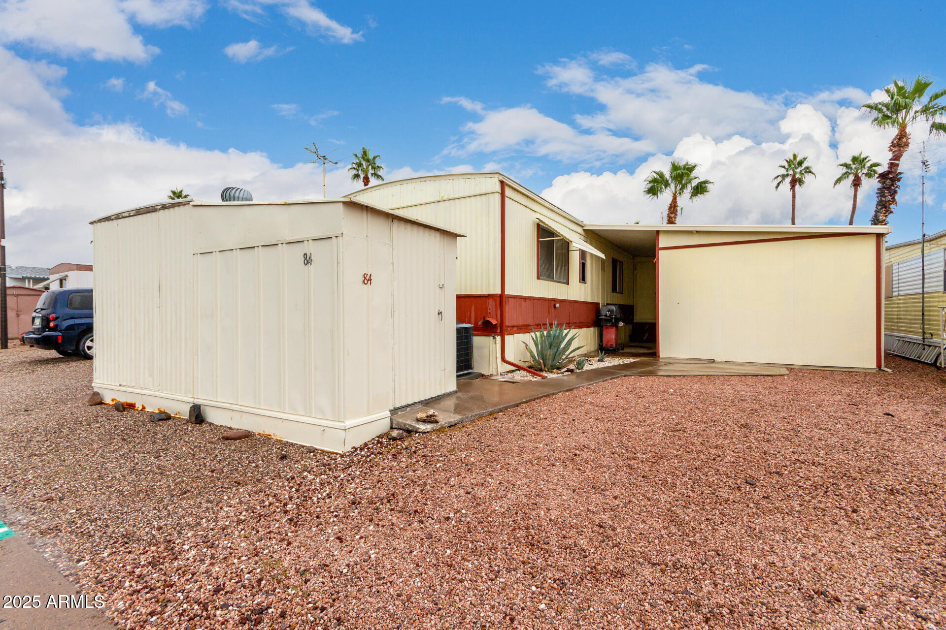1050 East Broadway Avenue, Unit 84 Apache Junction, AZ 85119 - Photo 19 of 34 a view of a house with a yard