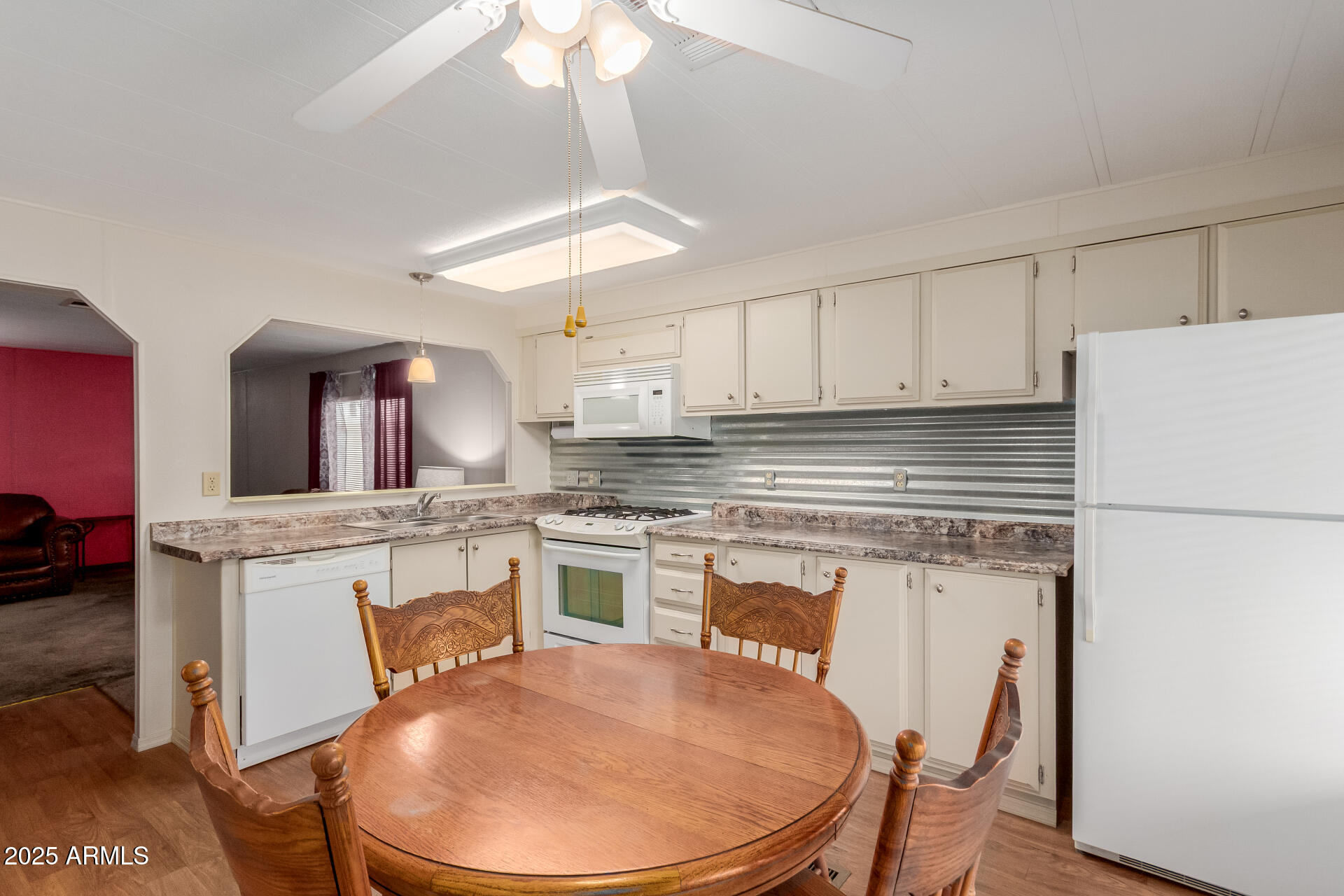 1050 East Broadway Avenue, Unit 84 Apache Junction, AZ 85119 - Photo 8 of 34 a kitchen with stainless steel appliances granite countertop a white cabinets and a stove