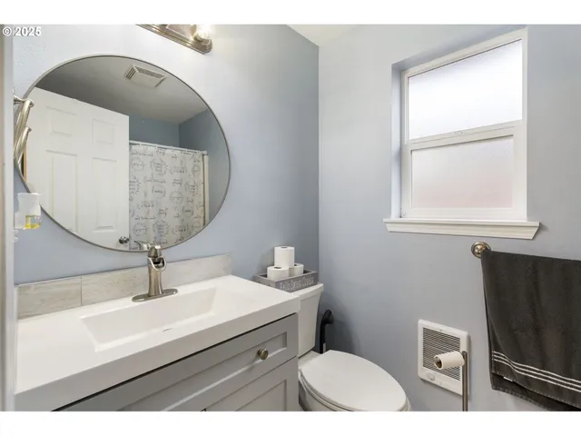 a bathroom with a sink a mirror and vanity