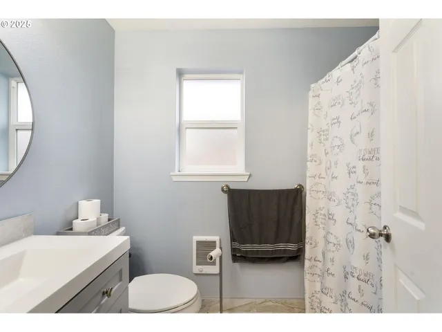 a bathroom with a sink a toilet and a mirror