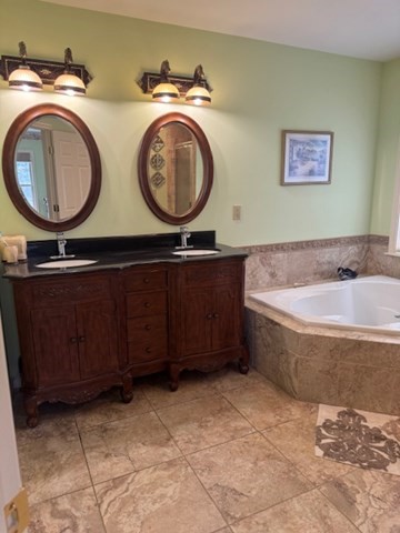 5 Gableview Lane Southwick, MA 01077 - Photo 23 of 31 a bathroom with a sink a mirror and a bathtub