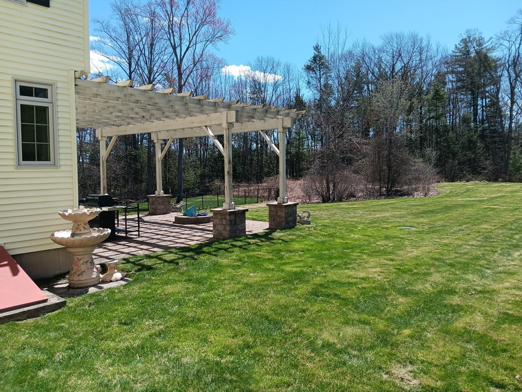 5 Gableview Lane Southwick, MA 01077 - Photo 4 of 31 a view of a patio with table and chairs under an umbrella