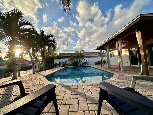 a view of a patio with swimming pool table and chairs