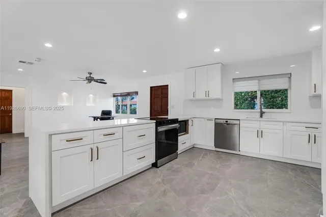 a kitchen with white cabinets and white appliances