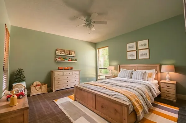 a bedroom with a bed and a chandelier