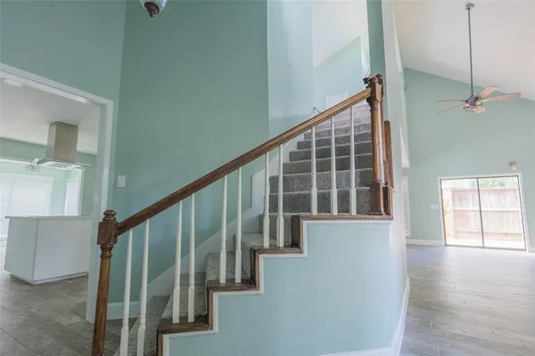 a view of staircase with white walls and windows
