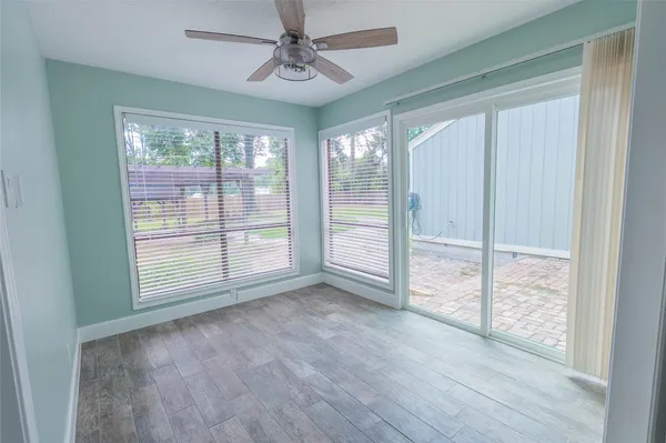a view of room with window and wooden floor