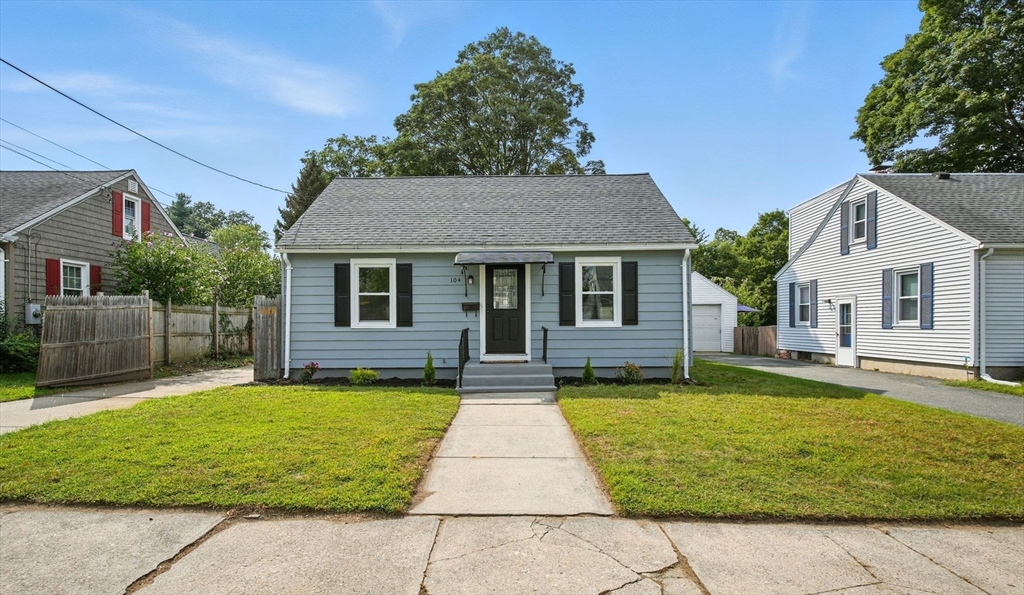 104 Grandview Street Springfield, MA 01118 - Photo 1 of 30 a front view of a house with a yard and garage