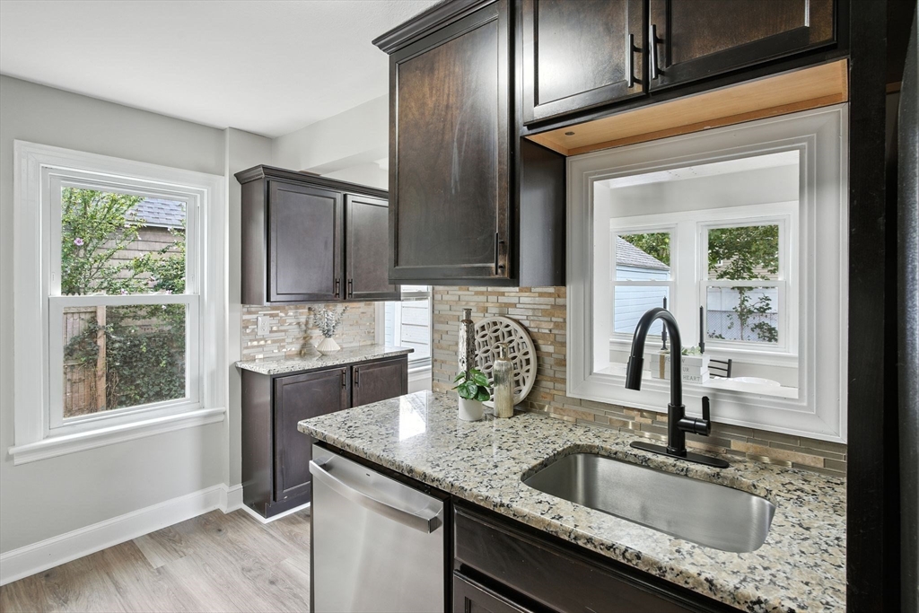104 Grandview Street Springfield, MA 01118 - Photo 8 of 30 a kitchen with granite countertop stainless steel appliances a sink stove and cabinets