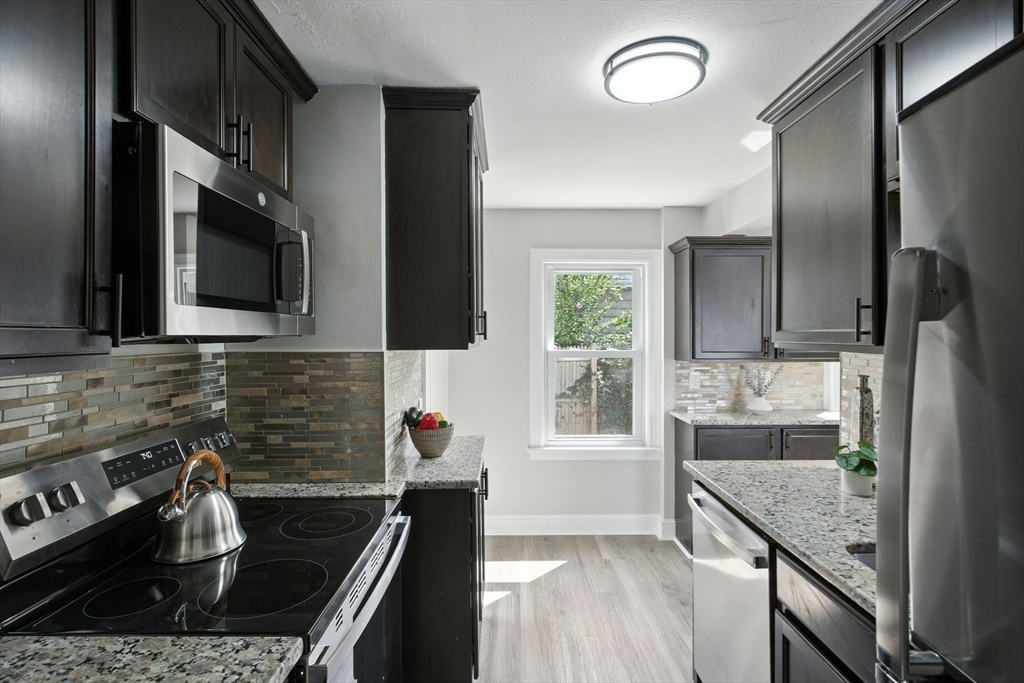 104 Grandview Street Springfield, MA 01118 - Photo 9 of 30 a kitchen with sink stove and cabinets