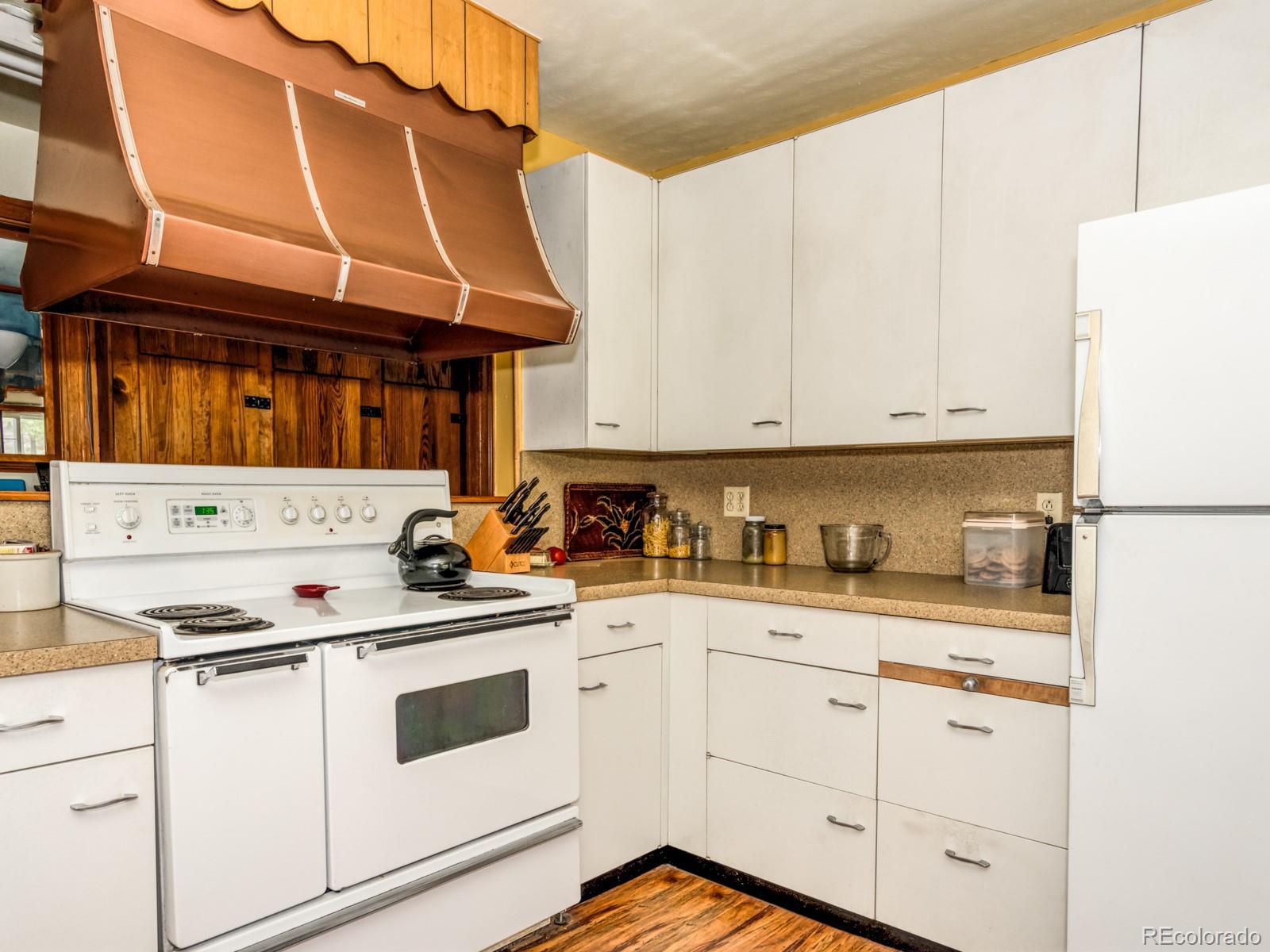 9695 Jones Road Franktown, CO 80116 - Photo 11 of 40 a kitchen with granite countertop a sink a stove and cabinets