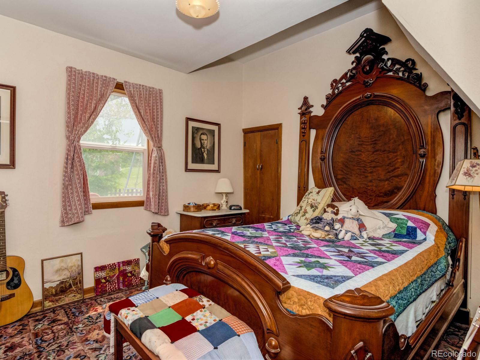 9695 Jones Road Franktown, CO 80116 - Photo 13 of 40 a bedroom with a bed and dresser