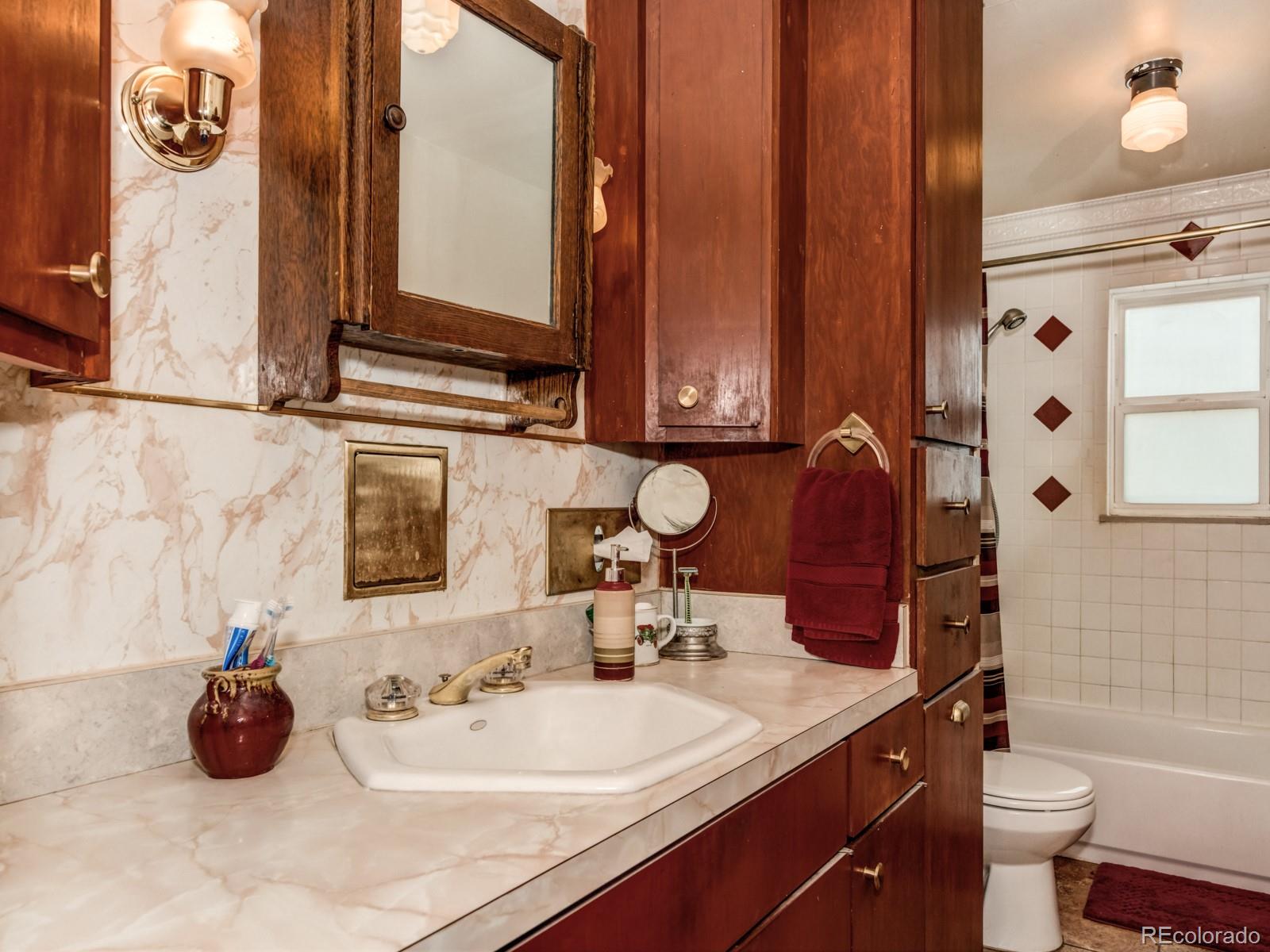 9695 Jones Road Franktown, CO 80116 - Photo 17 of 40 a bathroom with a sink and a mirror