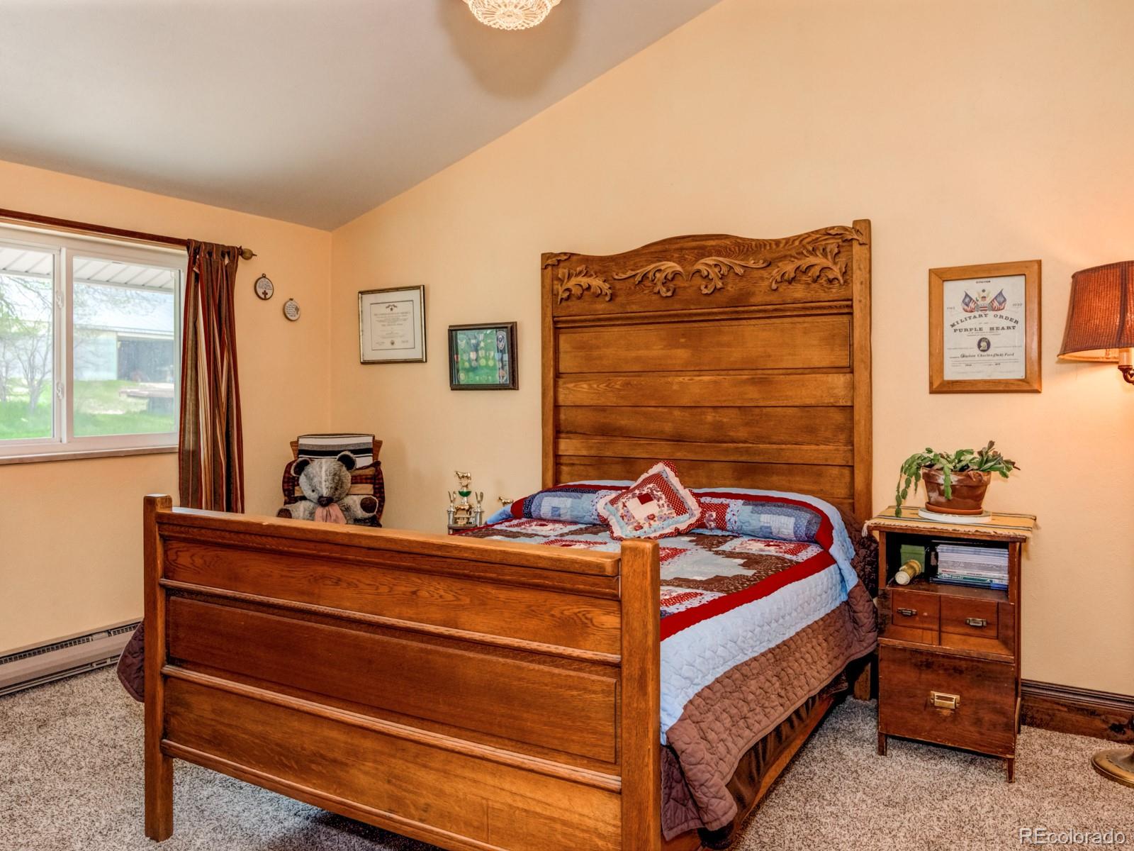 9695 Jones Road Franktown, CO 80116 - Photo 18 of 40 a bedroom with a bed and a dresser