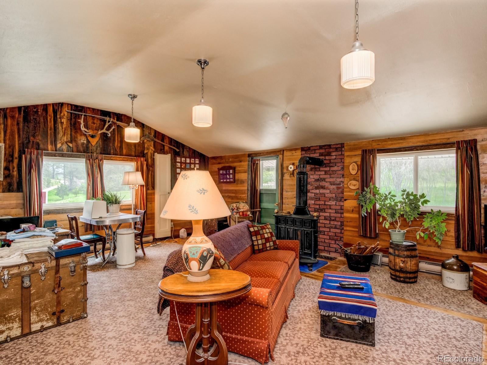 9695 Jones Road Franktown, CO 80116 - Photo 20 of 40 a living room with patio furniture and a chandelier