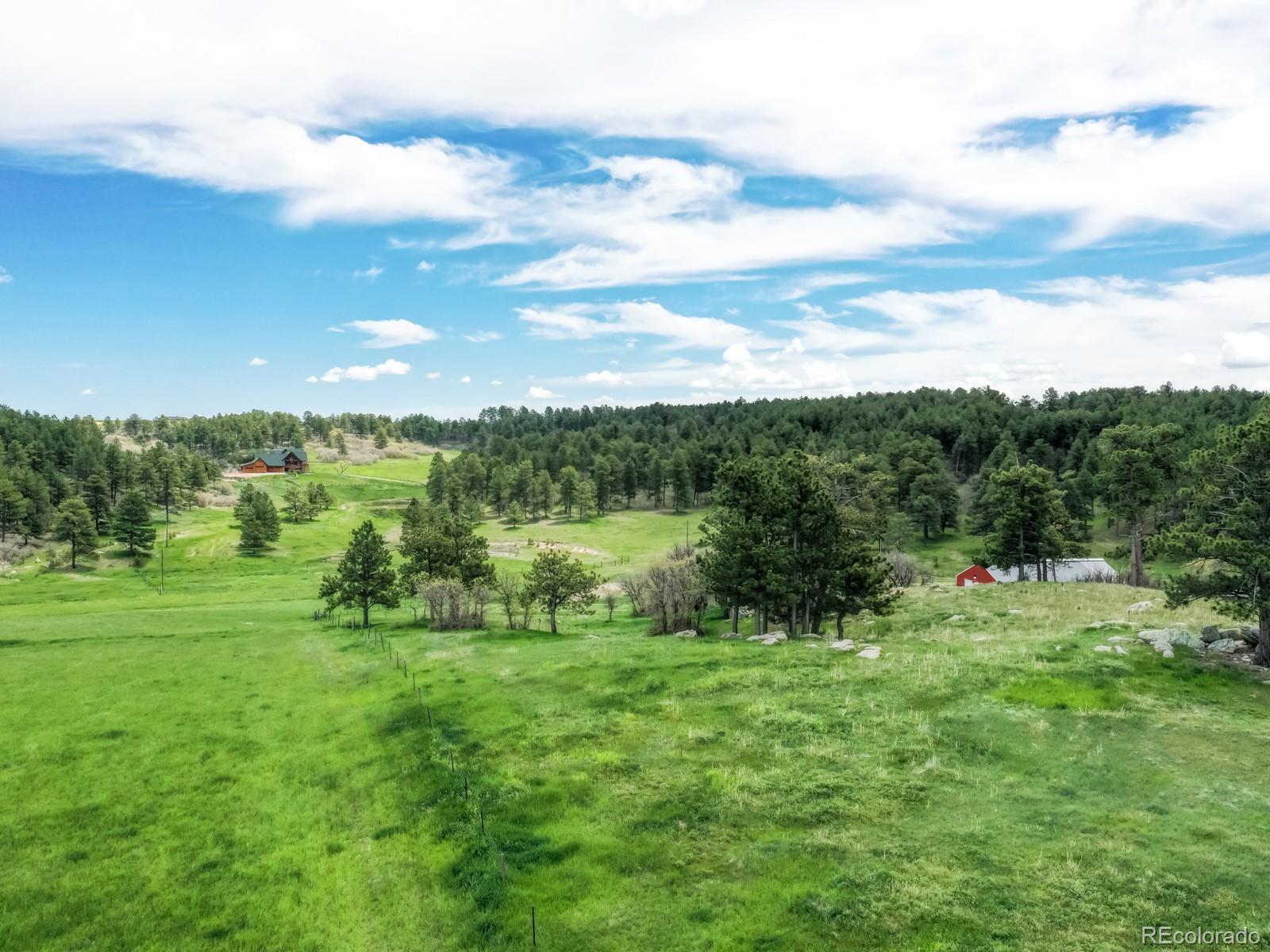 9695 Jones Road Franktown, CO 80116 - Photo 26 of 40 a view of outdoor space with deck and yard