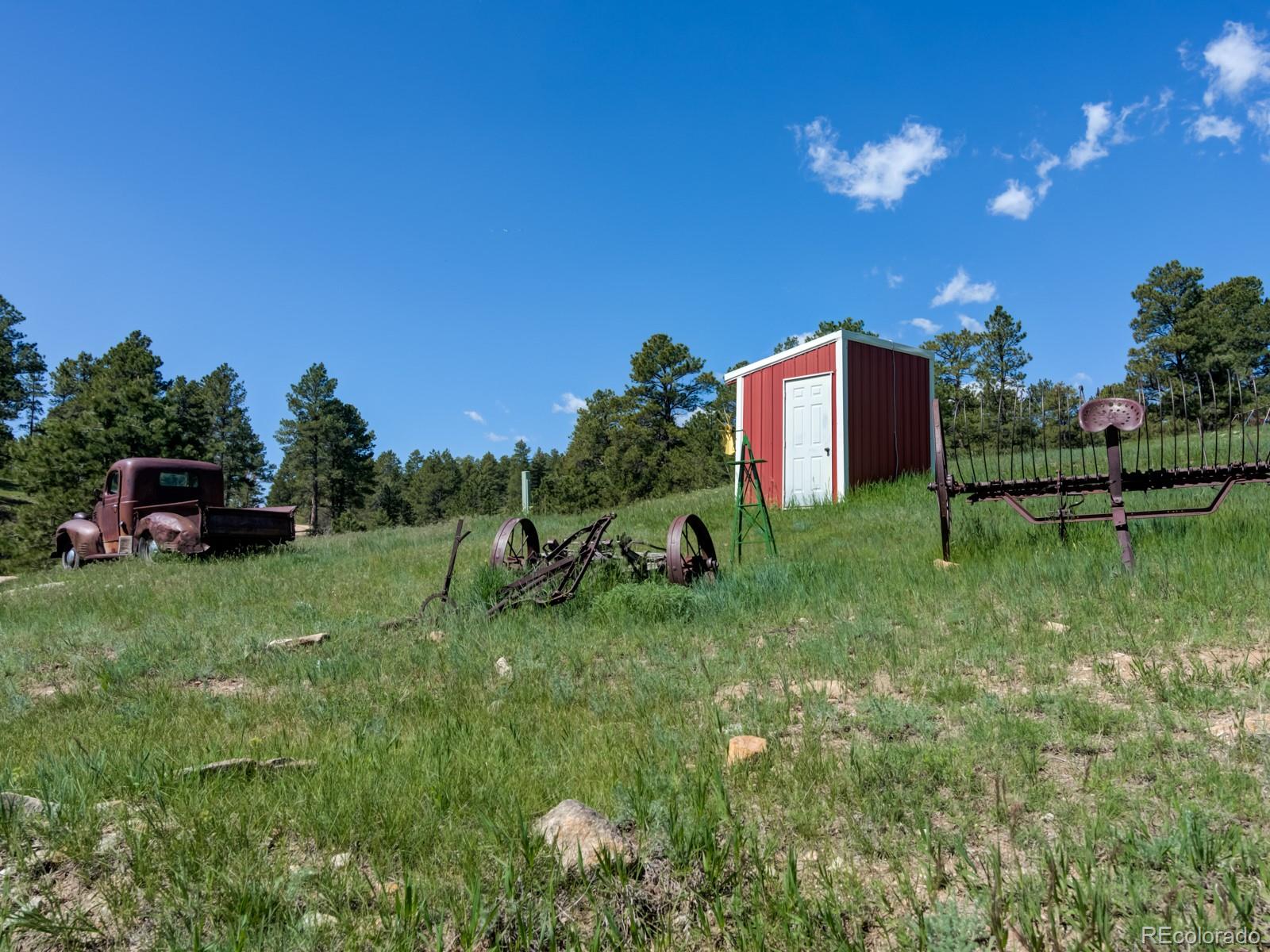 9695 Jones Road Franktown, CO 80116 - Photo 33 of 40 a view of a garden with a building in the background
