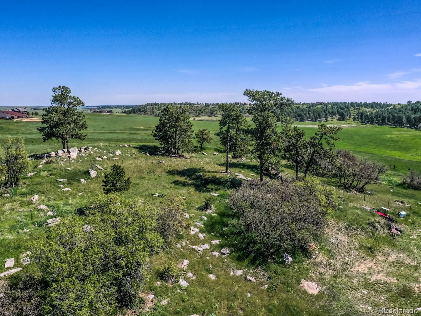 9695 Jones Road Franktown, CO 80116 - Photo 37 of 40 a view of a city with lush green forest