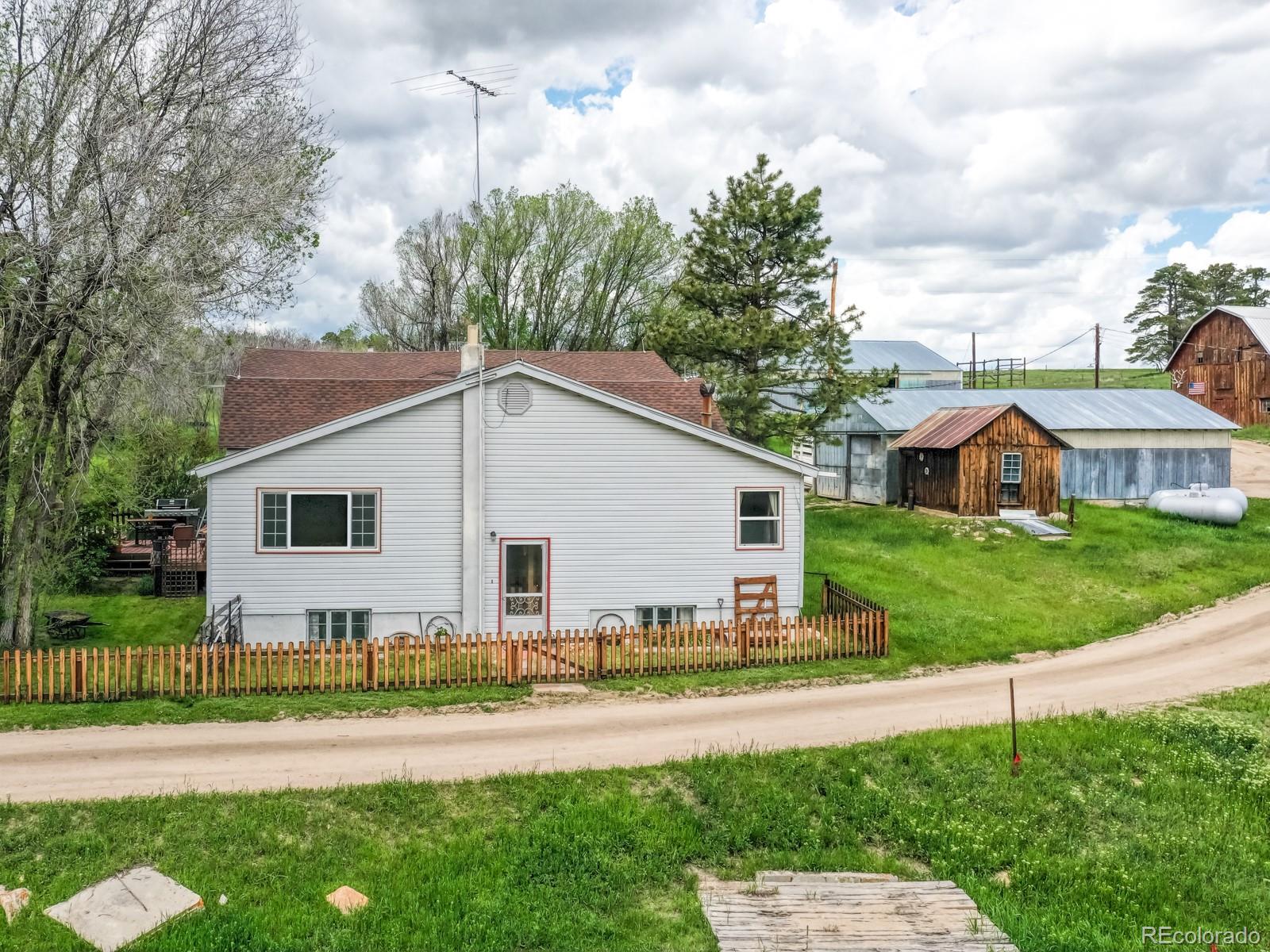 9695 Jones Road Franktown, CO 80116 - Photo 39 of 40 a front view of a house with a yard
