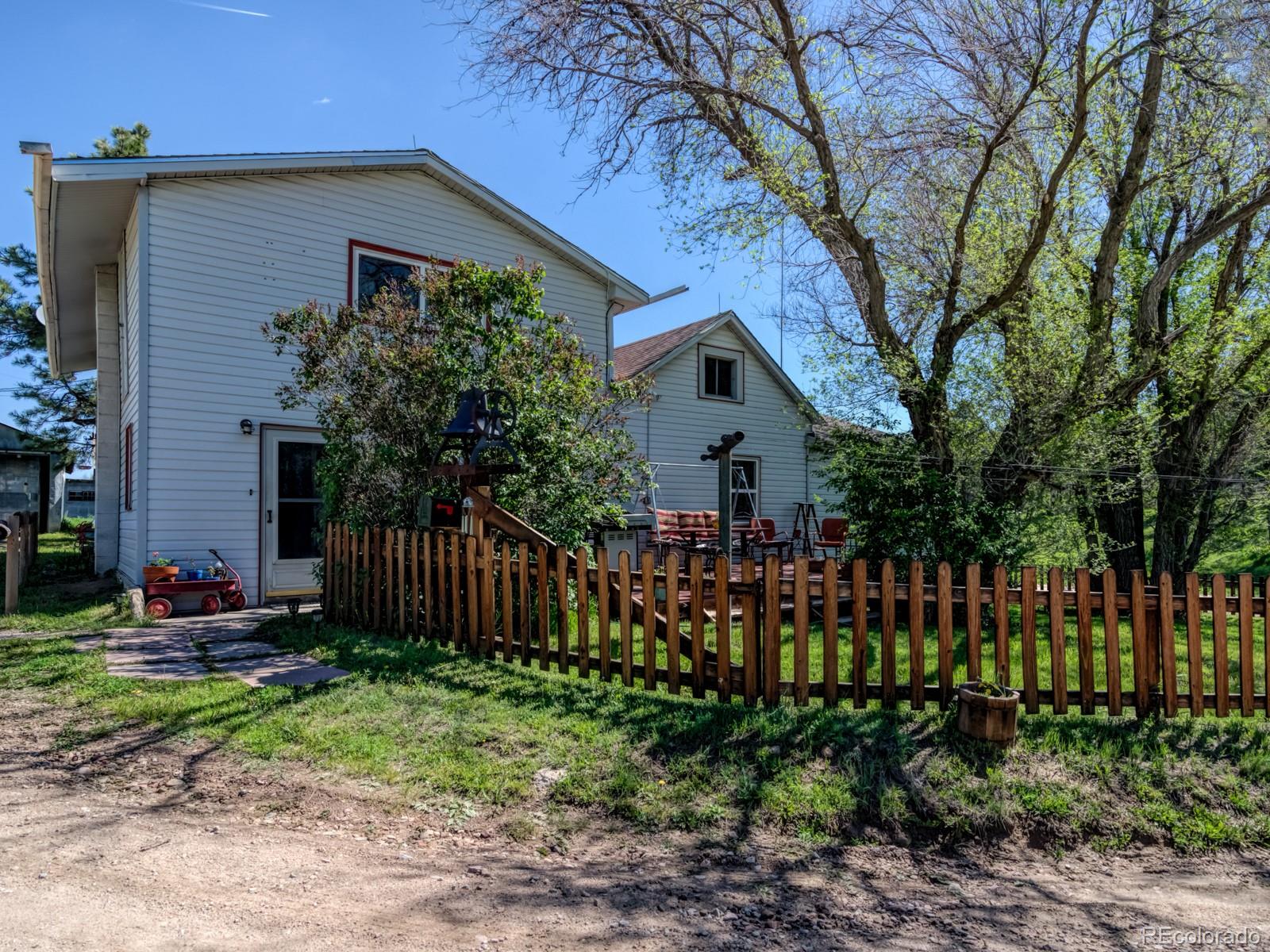 9695 Jones Road Franktown, CO 80116 - Photo 4 of 40 a front view of a house with garden