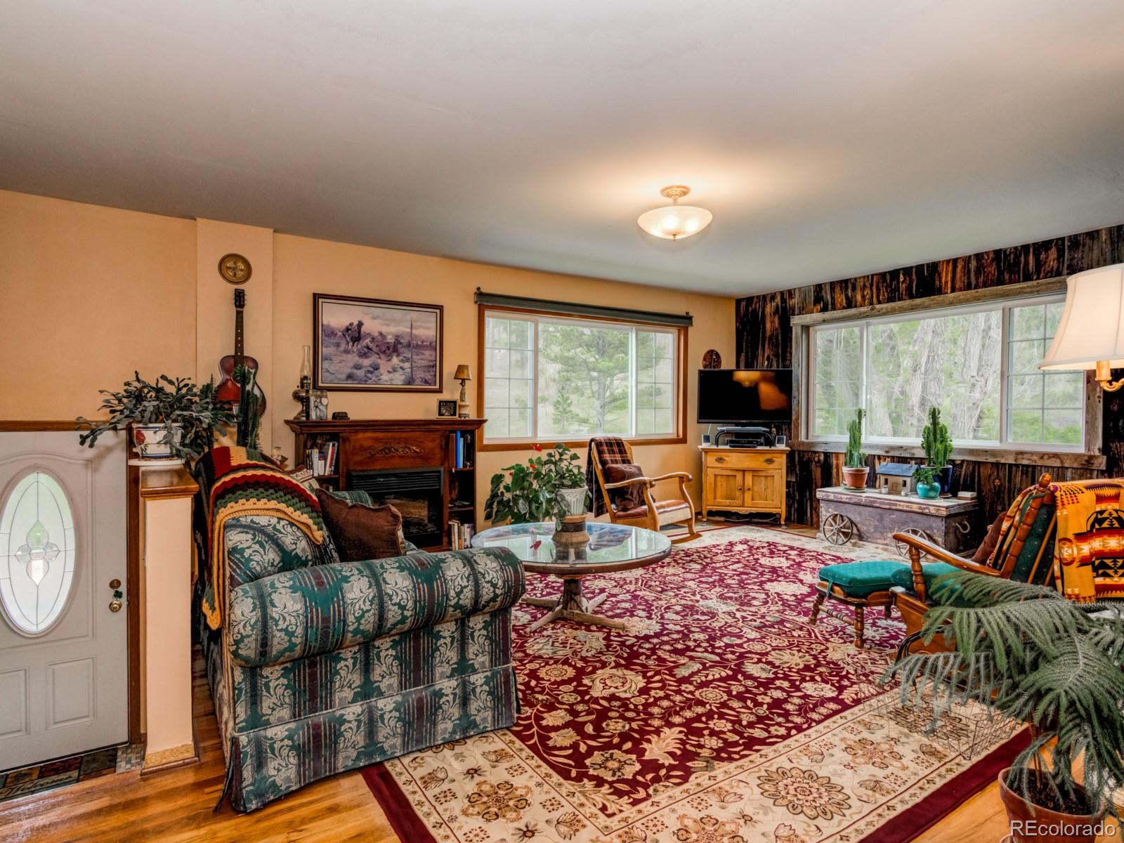9695 Jones Road Franktown, CO 80116 - Photo 6 of 40 a living room with furniture a rug and a large window