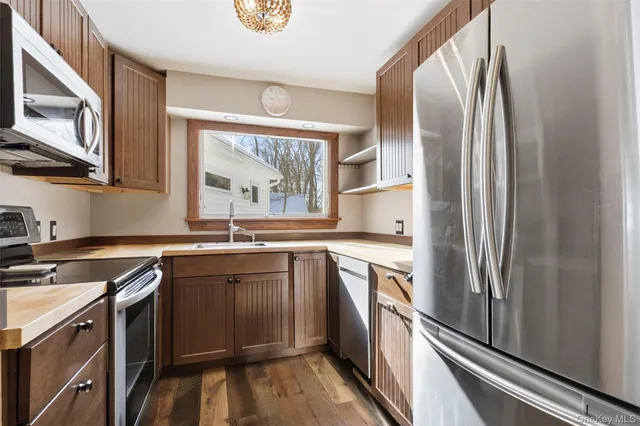 a kitchen with stainless steel appliances granite countertop a refrigerator and a sink