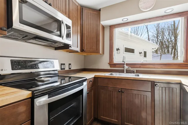 a kitchen with stainless steel appliances a stove sink and microwave
