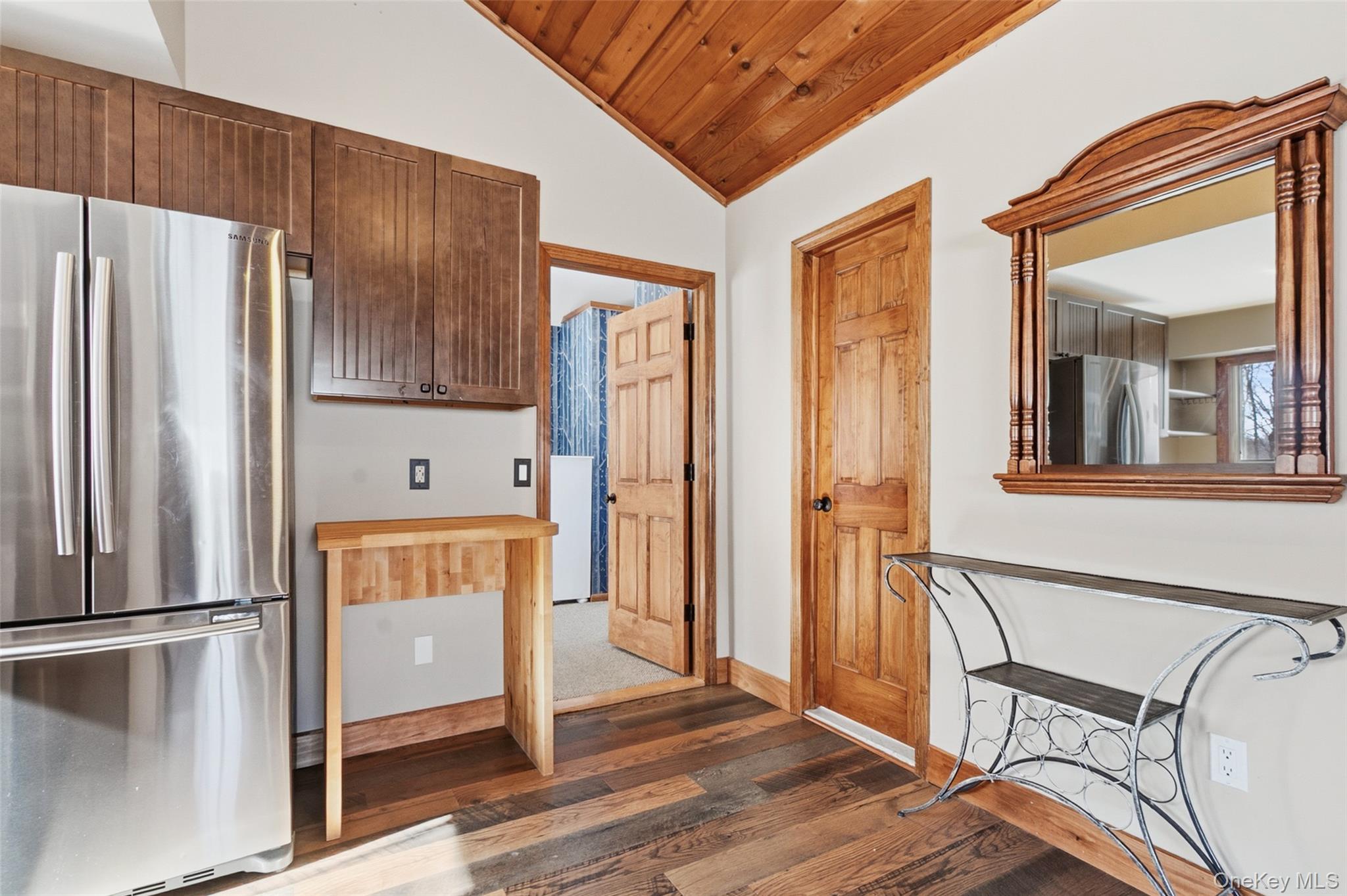 19 Curry Road Mahopac, NY 10541 - Photo 15 of 36 an empty room with wooden floor and a kitchen view