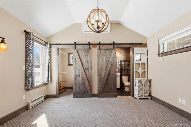 a view of a livingroom with wooden floor and a ceiling fan