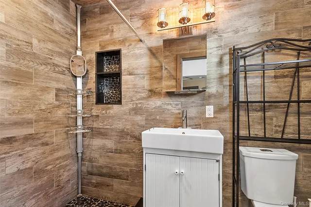a bathroom with a sink toilet and shower