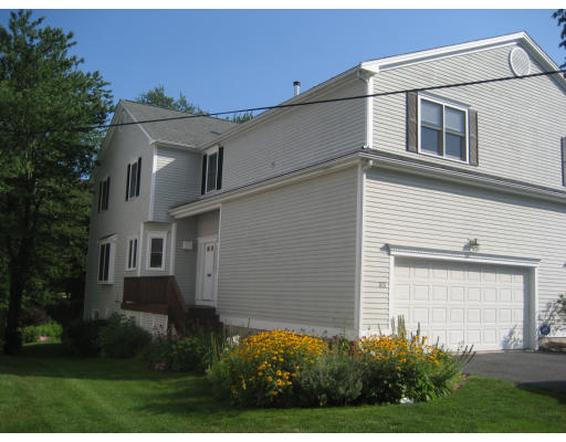 a view of a house with large windows and a yard