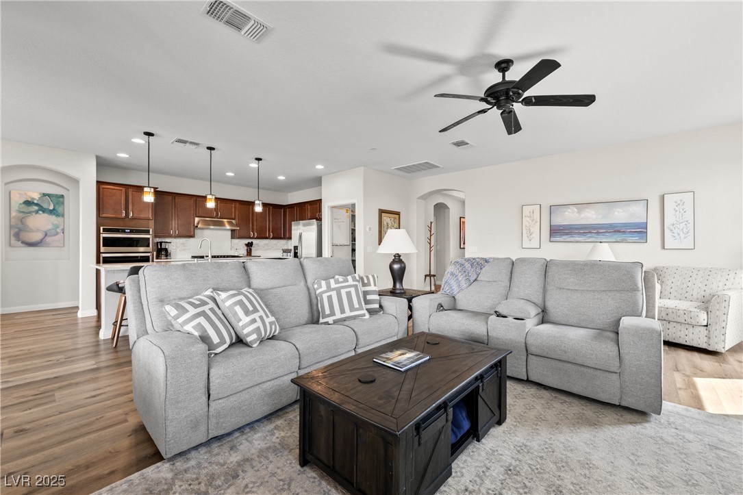 1221 Tortoise Ridge Mesquite, NV 89034 - Photo 16 of 56 Living room featuring arched walkways, recessed lighting, light wood-style flooring, and a ceiling fan
