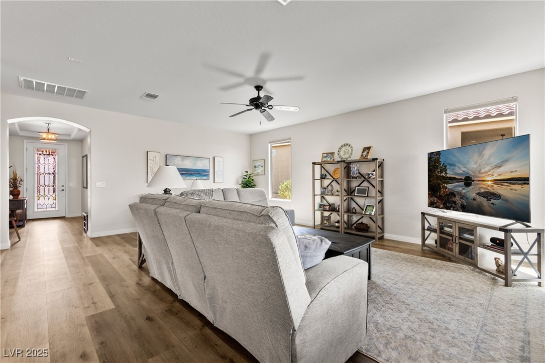 1221 Tortoise Ridge Mesquite, NV 89034 - Photo 17 of 56 Living room with arched walkways, plenty of natural light, a ceiling fan, and wood finished floors