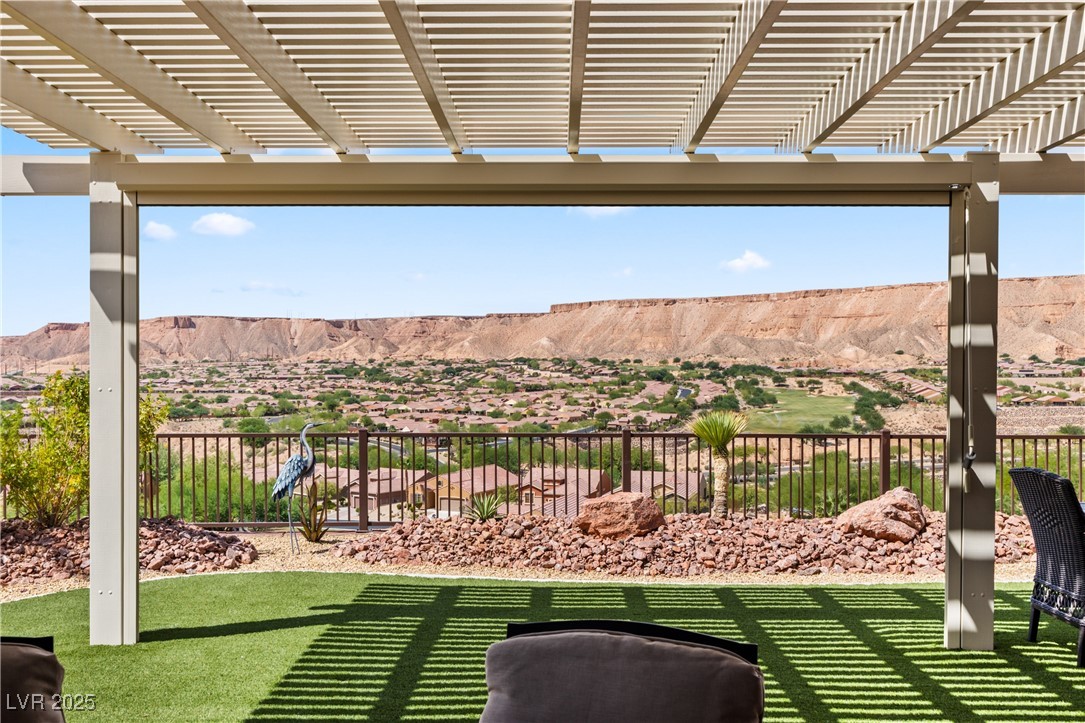 1221 Tortoise Ridge Mesquite, NV 89034 - Photo 2 of 56 View of yard featuring a pergola, a mountain view, and a patio