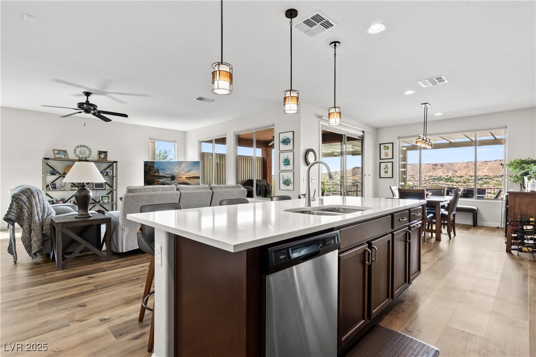1221 Tortoise Ridge Mesquite, NV 89034 - Photo 23 of 56 Kitchen with decorative light fixtures, stainless steel dishwasher, plenty of natural light, dark brown cabinets, and recessed lighting