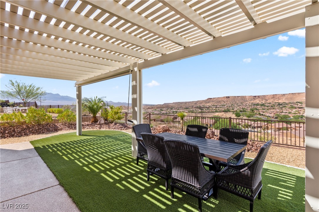1221 Tortoise Ridge Mesquite, NV 89034 - Photo 38 of 56 View of patio / terrace featuring a mountain view, outdoor dining space, and a pergola