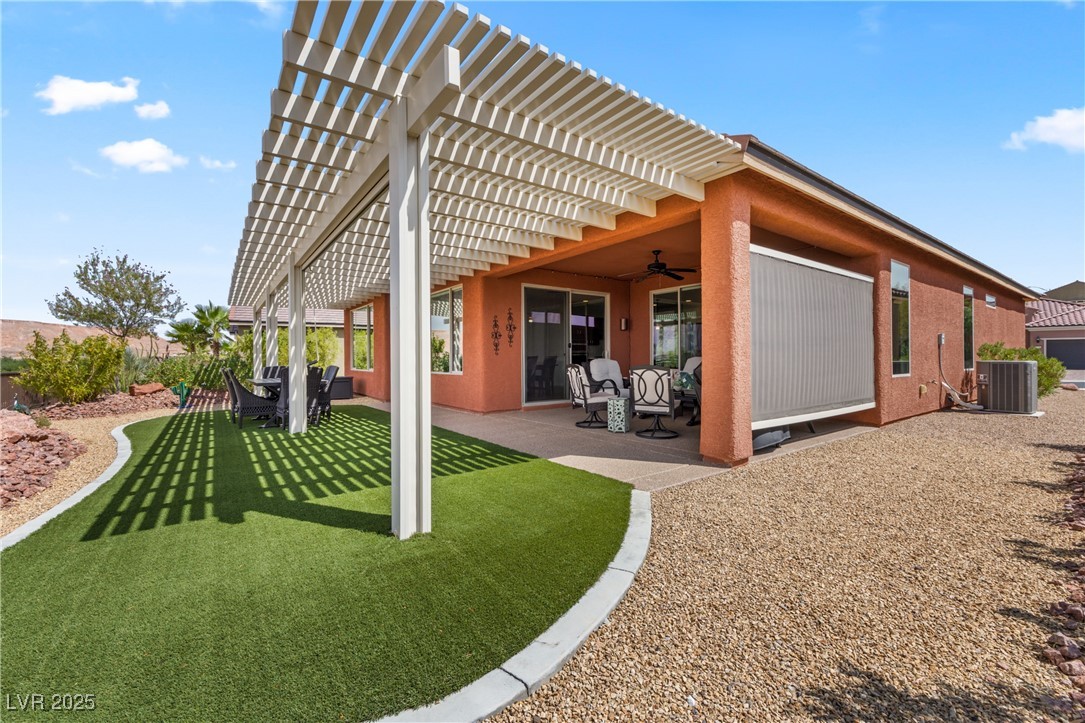 1221 Tortoise Ridge Mesquite, NV 89034 - Photo 42 of 56 Back of house featuring a pergola, a patio area, ceiling fan, and stucco siding