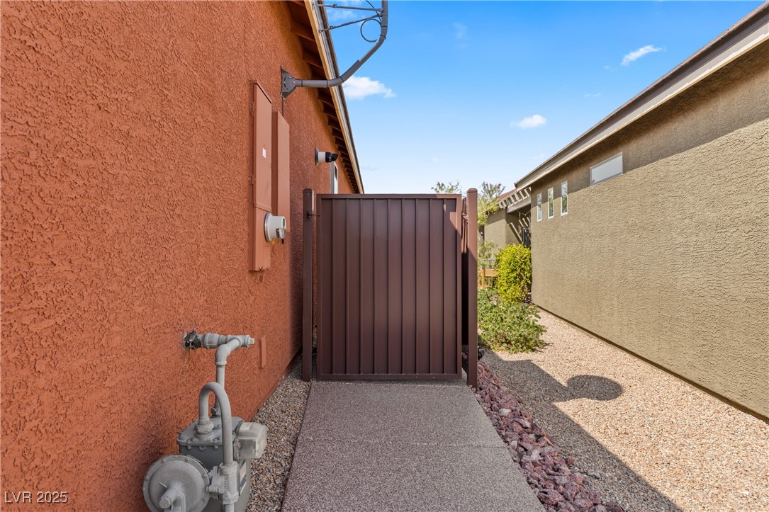 1221 Tortoise Ridge Mesquite, NV 89034 - Photo 43 of 56 View of property exterior with stucco siding and a gate