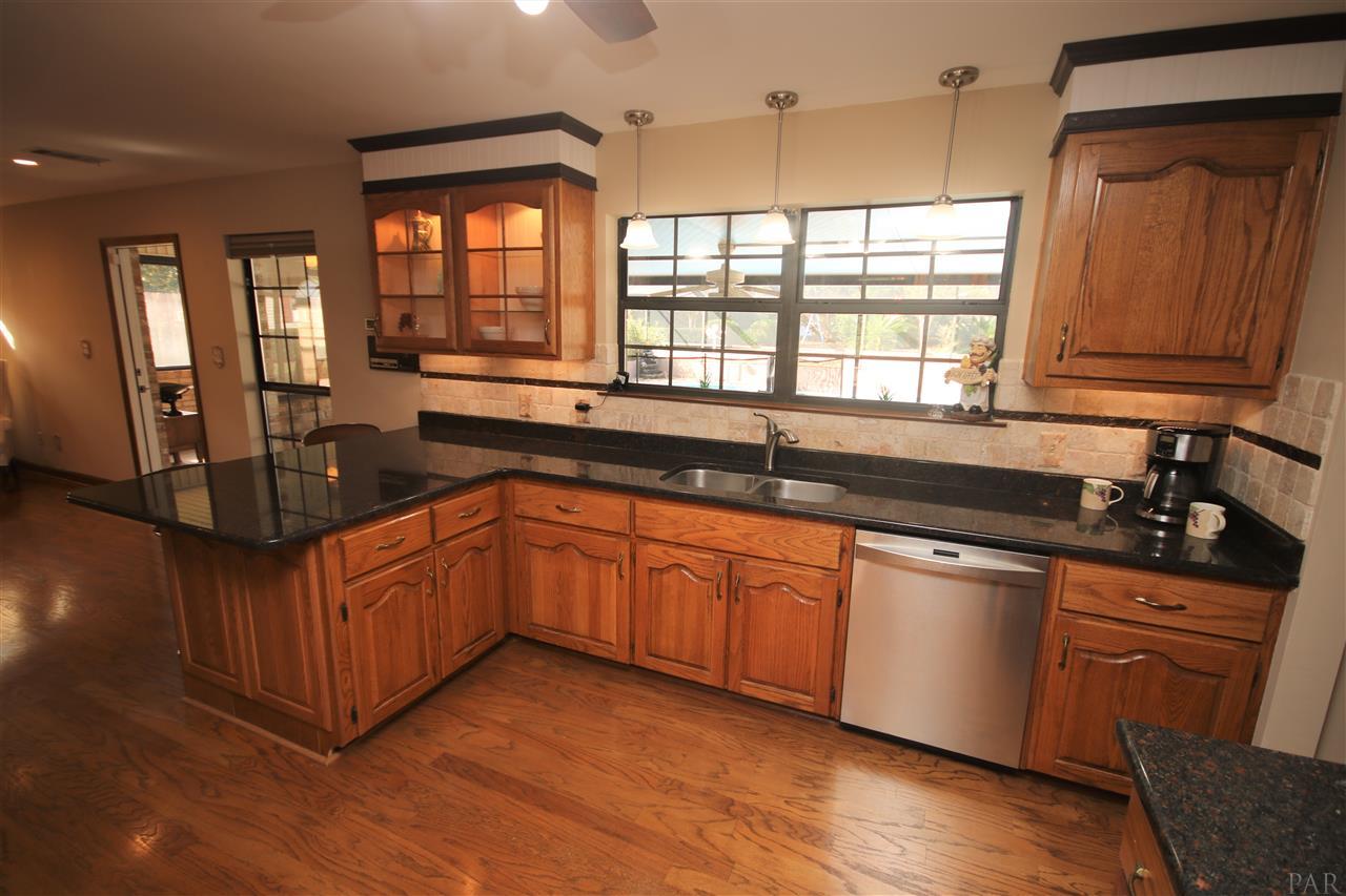 5017 Roland Road Pace, FL 32571 - Photo 13 of 50 w/3/4 horsepower disposal. Pendant lighting above.