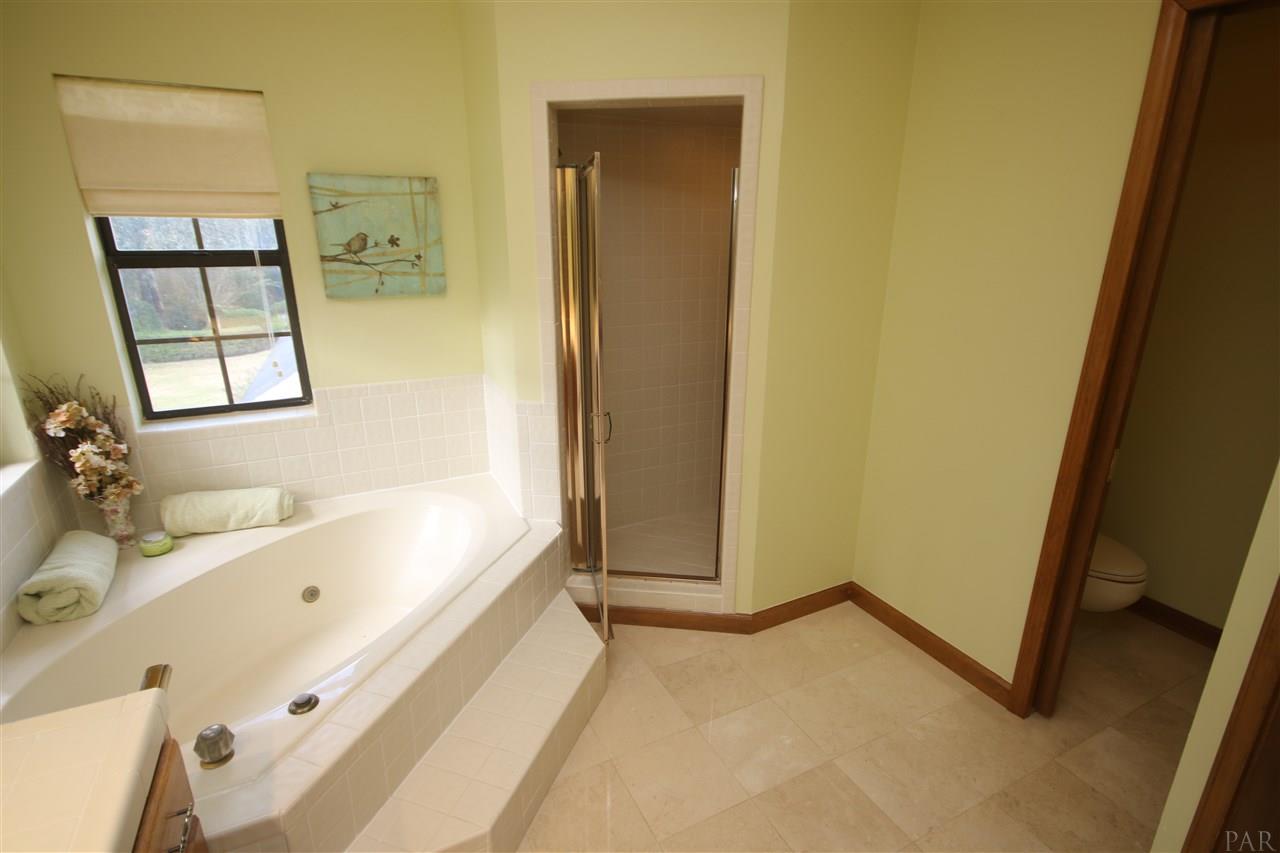 5017 Roland Road Pace, FL 32571 - Photo 38 of 50 shower w/seat. Skylight in center of bathroom.
