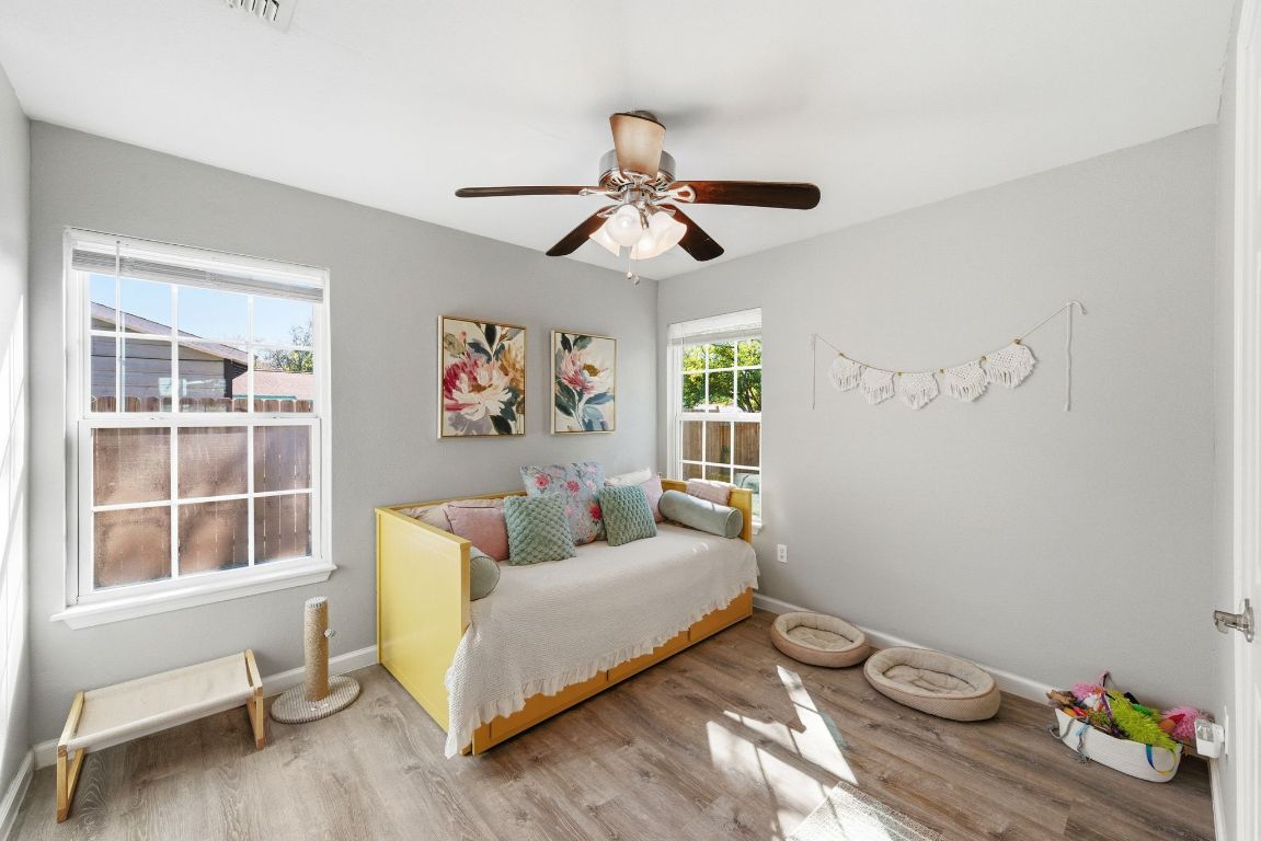 4615 Munson Street Austin, TX 78721 - Photo 19 of 27 Bedroom with wood finished floors and ceiling fan
