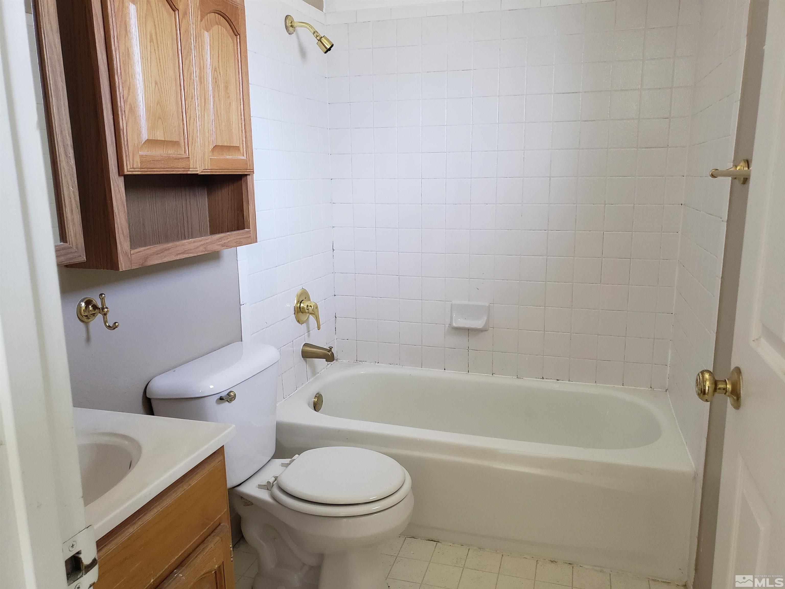 1545 Peavine Road Reno, NV 89503 - Photo 7 of 11 a bathroom with a sink a toilet and bathtub