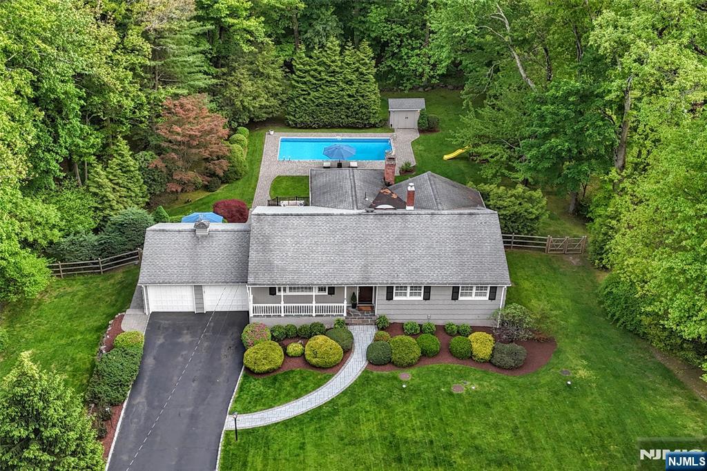 60 Dimmig Road Upper Saddle River, NJ 07458 - Photo 3 of 40 an aerial view of a house with swimming pool table and chairs