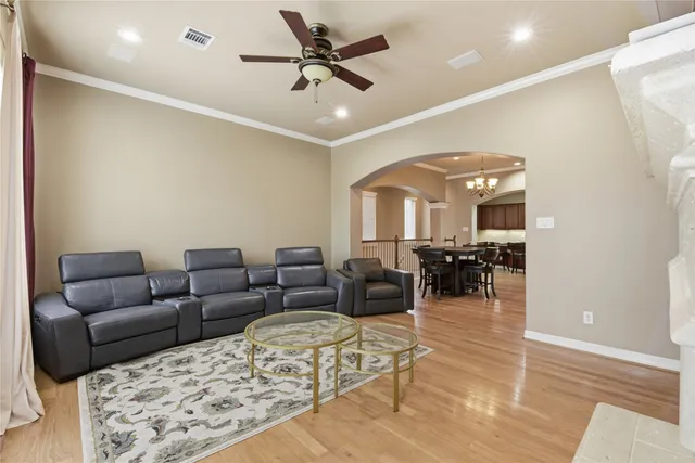 a living room with furniture and a chandelier