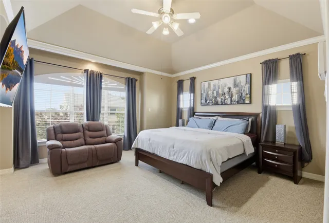 a spacious bedroom with a bed and a couch