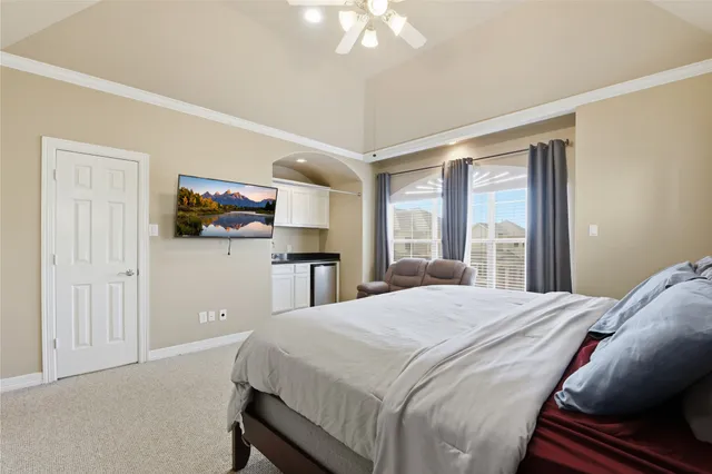 a bedroom with a bed and a flat screen tv