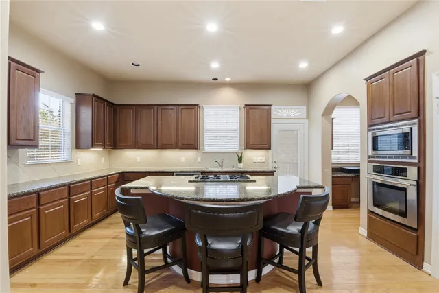 a kitchen with a dining table and chairs