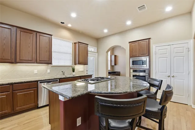 a kitchen with a sink cabinets and wooden floor