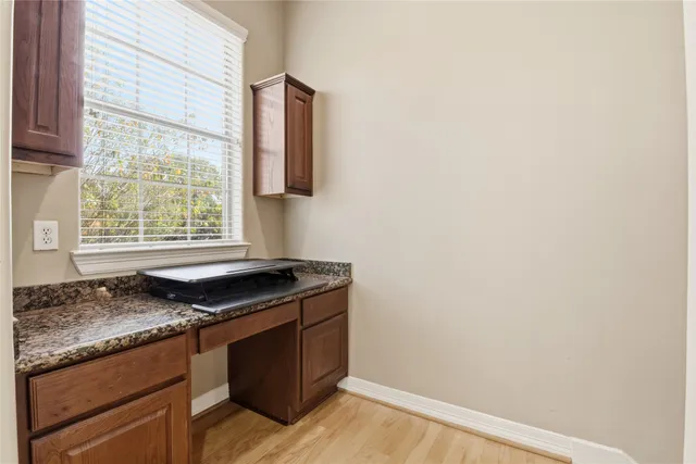 a kitchen with granite countertop a sink and a window